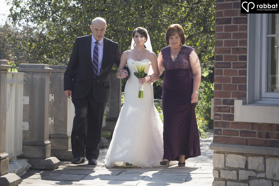 Bride walking down the aisle with both parents