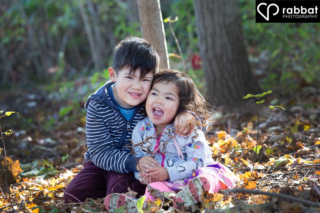 Happy siblings. Family portraits in the leaves.