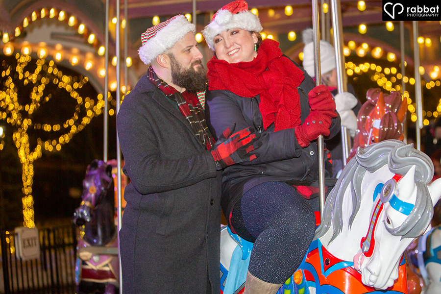 Woman on carousel, man smiling at her lovingly at Canada's Wonderland Winterfest