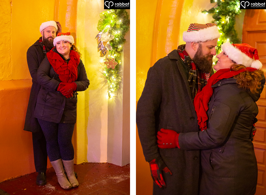 Winter wonderland engagement photos underneath arch with Christmas decorations.