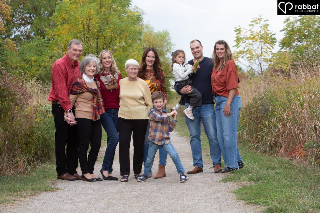 Outdoor extended family portrait with 9 people including two children. 