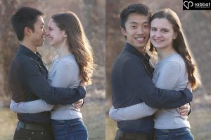 Side by side vertical photos of couple looking at camera with forest behind them. Man is Asian, woman is white. He is wearing a dark shirt and she is wearing a bluish gray long sleeve shirt. They are smiling at the camera and are backlit by the sun. In the photo on the left, they are touching noses. and hugging. In the photo on the right, they are hugging and looking at the camera.
