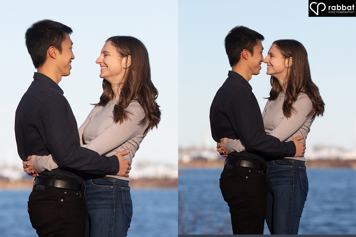 Engagement photos at Cherry Beach. Side by side vertical photos of a couple standing in front of Lake Ontario on a sunny evening with a blue sky in the background. In the photo on the left, they are hugging and looking at each other with their heads apart. In the photo on the right, they look like they are about to kiss. Both photos are from tjhe waist up. Man is Asian, woman is white with brown hair. They are both wearing black pants. He is wearing a long-sleeve black shirt and she is wearing a long-sleeve grayish blue shirt.