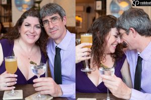 Couple dressed in fancy purple clothes about to enjoy cocktails and kiss.